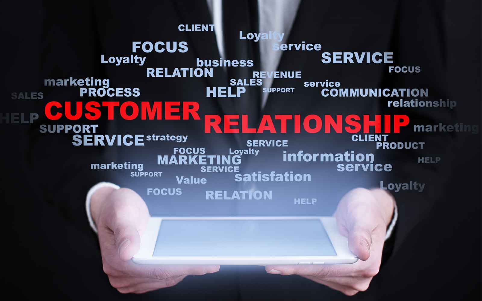 Person holding a tablet surrounded by customer relationship, service and loyalty terms