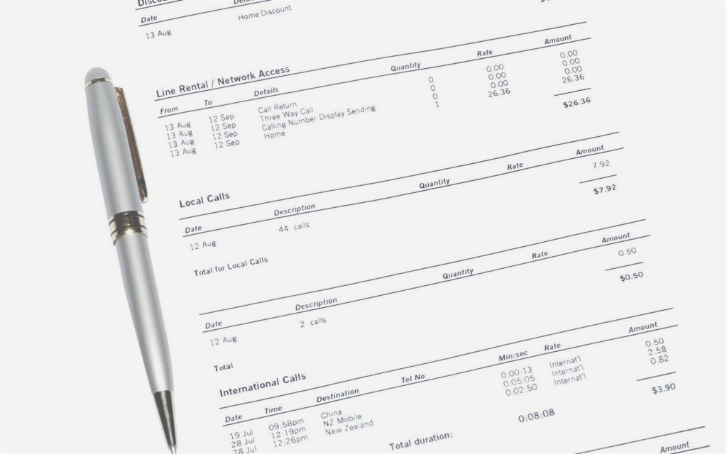 Close-up of a printed telecommunications bill with itemised calls and a pen